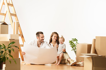 Image showing Couple moving to a new home - Happy married people buy a new apartment to start new life together