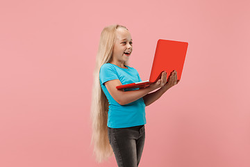 Image showing The happy child with red laptop on pink