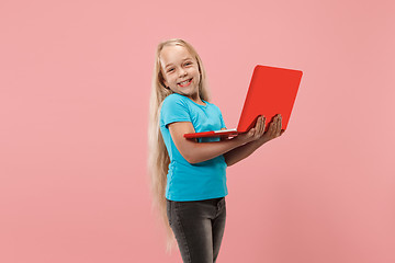 Image showing The happy child with red laptop on pink