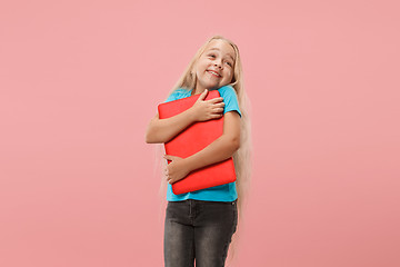 Image showing The happy child with red laptop on pink