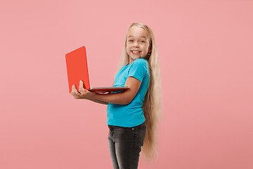 Image showing The happy child with red laptop on pink