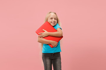 Image showing The happy child with red laptop on pink