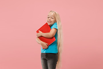 Image showing The happy child with red laptop on pink