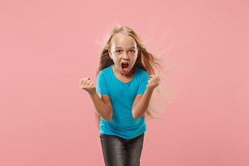 Image showing Portrait of angry teen girl on a pink studio background