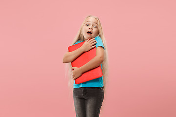 Image showing The happy child with red laptop on pink