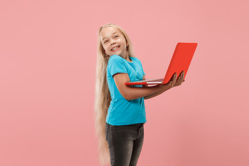 Image showing The happy child with red laptop on pink