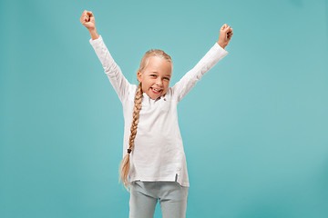 Image showing Happy success teen girl celebrating being a winner. Dynamic energetic image of female model