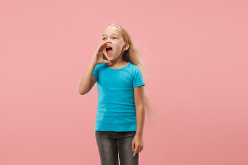 Image showing Isolated on pink young casual teen girl shouting at studio