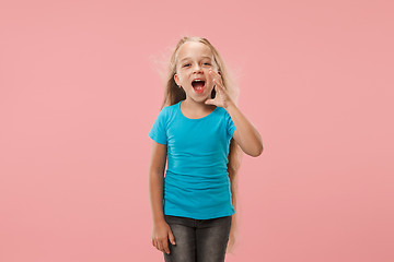 Image showing Isolated on pink young casual teen girl shouting at studio