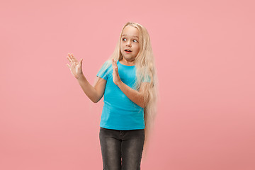 Image showing Portrait of the scared girl on pink