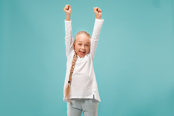 Image showing Happy success teen girl celebrating being a winner. Dynamic energetic image of female model