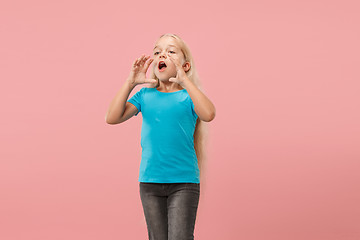 Image showing Isolated on pink young casual teen girl shouting at studio