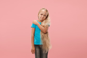 Image showing Young girl overwhelmed with a pain in the shoulder