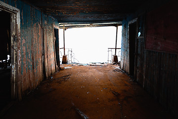 Image showing An abandoned rusty corridor with light at the end