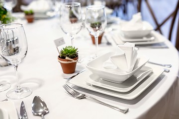 Image showing Plates and dishes on dining table