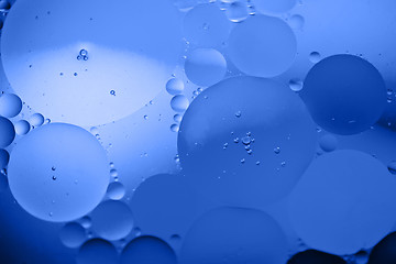 Image showing Defocused abstract background picture made with oil, water and soap. Blue toned.
