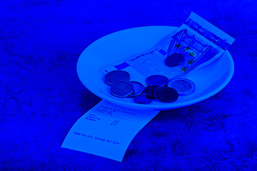 Image showing Tip on a restaurant table. Blue toned.