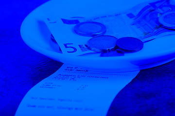 Image showing Tip on a restaurant table. Blue toned.