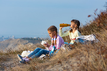 Image showing Girls on a rest on a halt and drink water