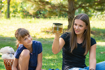 Image showing Girl and girl have fun at a teapot at a picnic