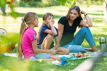 Image showing Sisters of different ages talking cute on a picnic