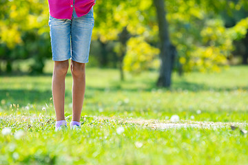 Image showing Children\'s feet are on the lawn in the park. Close-up