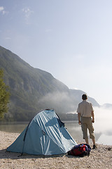 Image showing Man standing at mountain lake