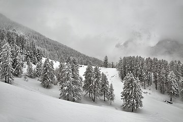 Image showing Skiing slopes, snowy Alpine landscape, mist overcas weather