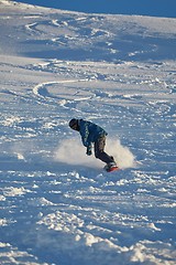 Image showing Snowboarding in fresh powder snow