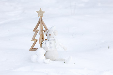 Image showing Simple Christmas tree, baubles and decoration in fresh snow