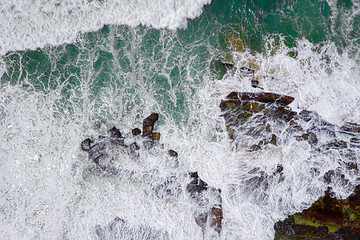 Image showing Overhead wave action over coastal rocks