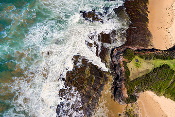 Image showing Views over the steep headland to the rocky shores and beach below