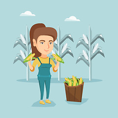 Image showing Young caucasian farmer collecting corn harvest.