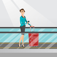 Image showing Woman using smartphone on escalator at the airport