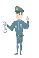 Image showing Young caucasian policeman holding handcuffs.