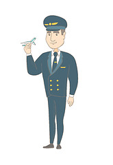 Image showing Young caucasian pilot with the model of airplane.