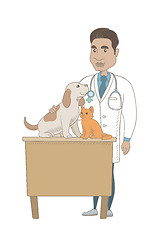 Image showing Young hispanic veterinarian examining pets.