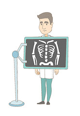 Image showing Caucasian roentgenologist during x ray procedure.