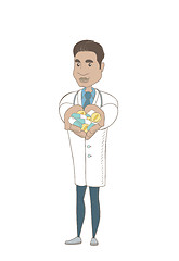 Image showing Young hispanic pharmacist giving pills.