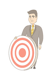 Image showing Young caucasian businessman and dart board.