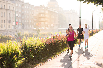 Image showing group of young people jogging in the city