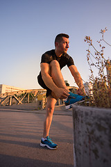 Image showing man tying running shoes laces