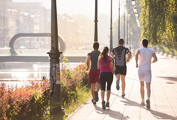 Image showing group of young people jogging in the city