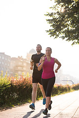 Image showing young couple jogging  in the city