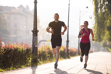 Image showing young couple jogging  in the city