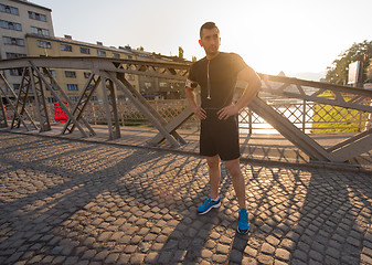 Image showing portrait of a jogging man at sunny morning