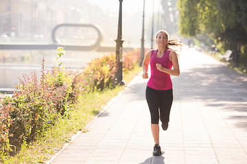 Image showing woman jogging at sunny morning