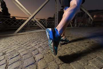 Image showing man jogging across the bridge in the city