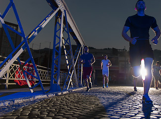 Image showing young people jogging across the bridge