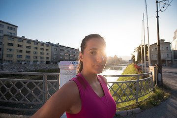 Image showing portrait of a jogging woman at sunny morning